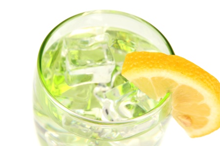 Glass with water and ice isolated on whiteの写真素材