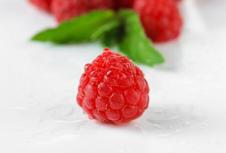 Ripe sweet raspberries isolated on white