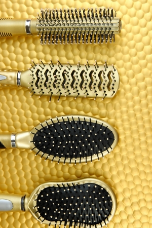 Hairbrushes on color backgroundの写真素材