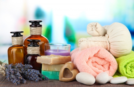Still life with lavender candle, soap, massage balls, soap and fresh lavender, on bright backgroundの写真素材