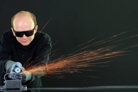 Portrait of workman in black glasses, isolated on blackの写真素材