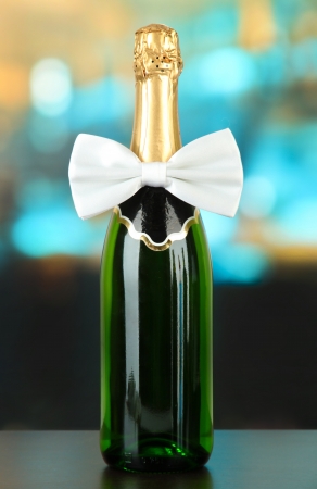 White bow tie on champagne bottle on bright backgroundの写真素材