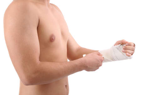 Young man with elastic bandage on hand, isolated on whiteの写真素材
