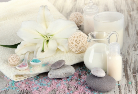 Beautiful spa setting with lily on wooden table close-upの写真素材