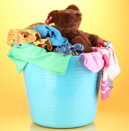 Blue laundry basket on orange backgroundの写真素材