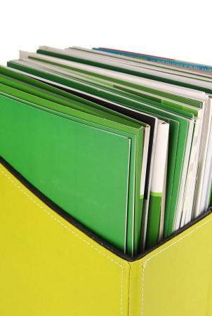 Magazines and folders in green box, isolated on whiteの写真素材