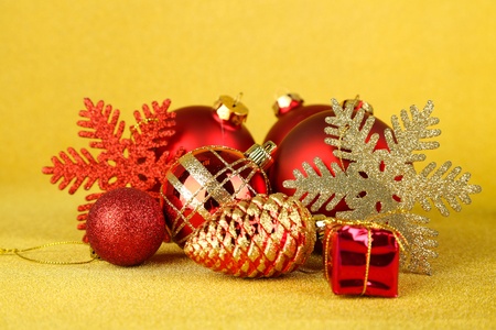 Christmas balls and small gift on yellow backgroundの写真素材