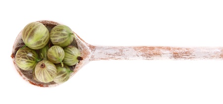 Gooseberry in wooden spoon isolated on whiteの写真素材