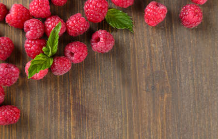 Ripe sweet raspberries on wooden backgroundの写真素材