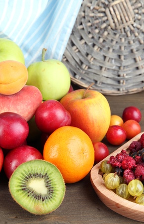 Assortment of juicy fruits, on wooden backgroundの写真素材