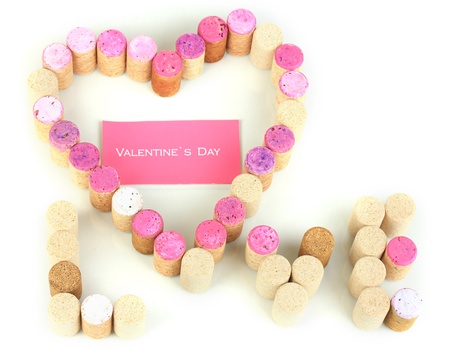Wine corks laid out in form of heart isolated on whiteの写真素材