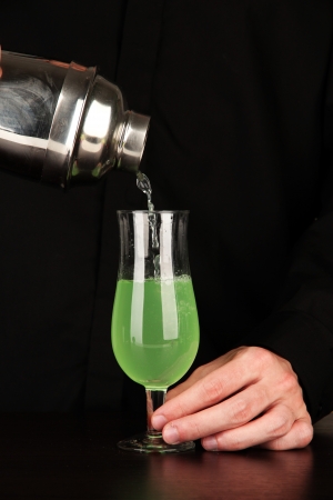 Bartender making cocktail on bright background, close-upの写真素材