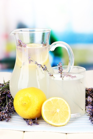 Lavender lemonade in glass jug, on napkin, on bright backgroundの写真素材