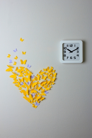 Office clock on color wall backgroundの写真素材