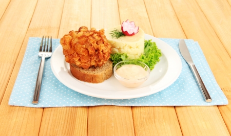 Chicken Kiev on croutons with mashed potatoes, on wooden backgroundの写真素材