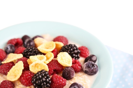 Oatmeal in bowl with berries isolated on whiteの写真素材