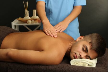 Young man having back massage close upの写真素材