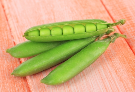 Sweet green peas on wooden backgroundの写真素材