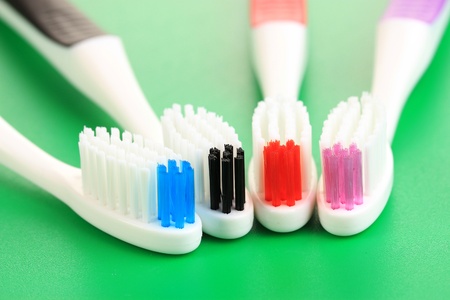 Tooth-brushes on green backgroundの写真素材