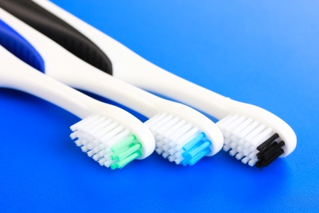 Tooth-brushes on blue backgroundの写真素材