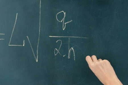 Physics formula written on blackboard with chalk.の写真素材