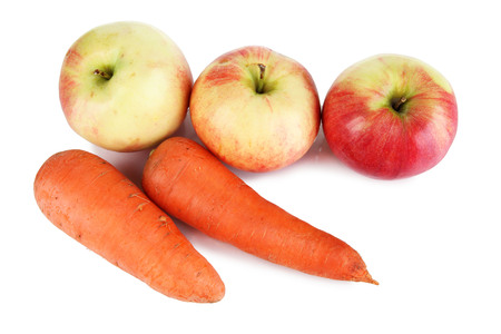 Sweet apples and carrots isolated on whiteの写真素材