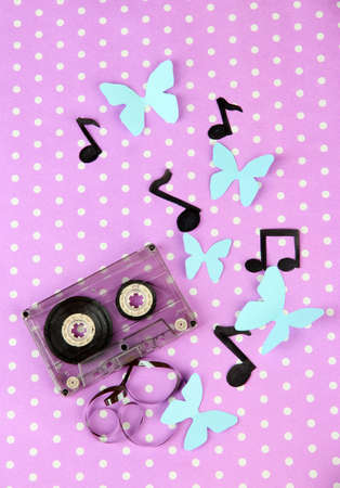 Old cassette on purple background
