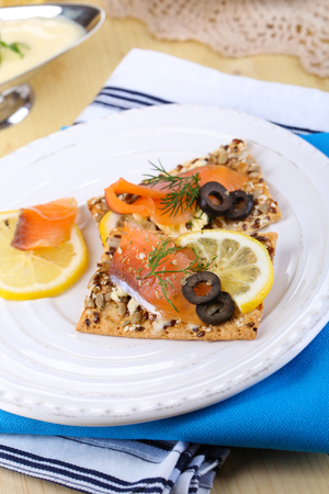 Salmon sandwiches on plate  on wooden table close-upの写真素材