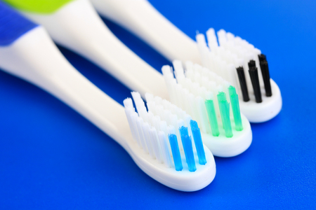 Tooth-brushes on blue backgroundの写真素材