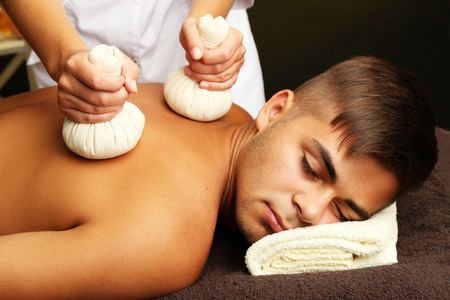 Young man having back massage close upの写真素材