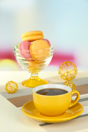 Coffee and macaroons on table on light backgroundの写真素材