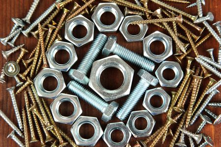 Bolts, screws and nuts on wooden table