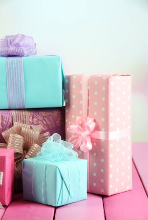 Beautiful bright gifts, on bright wooden tableの写真素材