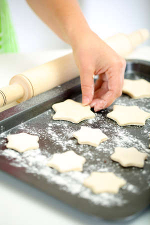 Woman in kitchen during cooking biscuits, close upの写真素材