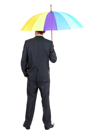 Businessman with multicolor umbrella, isolated on whiteの写真素材