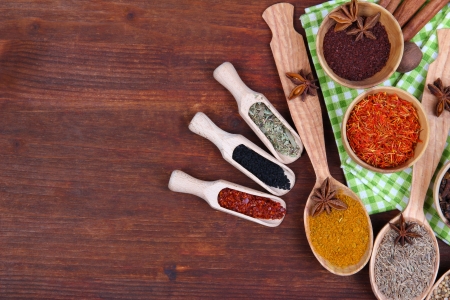 Various spices and herbs on wooden backgroundの写真素材