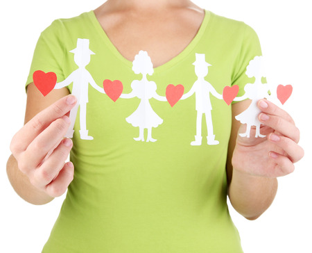 Paper people in hands isolated on whiteの写真素材