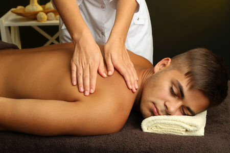 Young man having back massage close upの写真素材