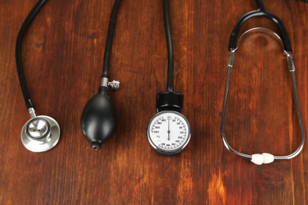 Tonometer and stethoscope on wooden table close-upの写真素材