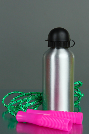 Sports bottle and skipping rope on grey backgroundの写真素材