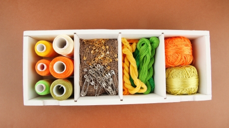 Thread and materials for handiwork in box on brown の写真素材