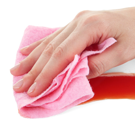 Hand wiping surface with pink rag isolated on whiteの写真素材