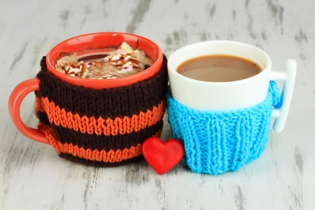Cups with knitted things on it on wooden table close upの写真素材