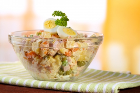 Russian traditional salad Olivier,  on wooden  table, on bright の写真素材