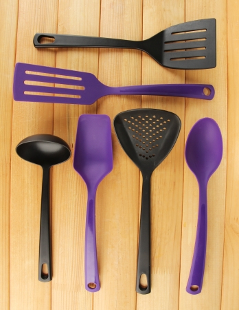 Plastic kitchen utensils on wooden backgroundの写真素材