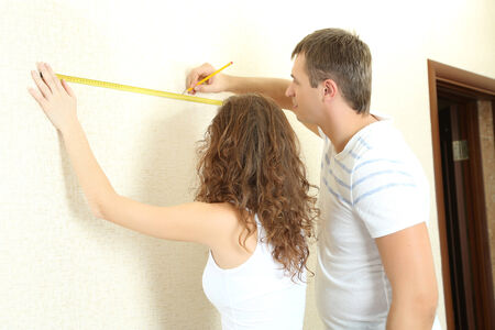 Young couple doing renovation in new houseの写真素材