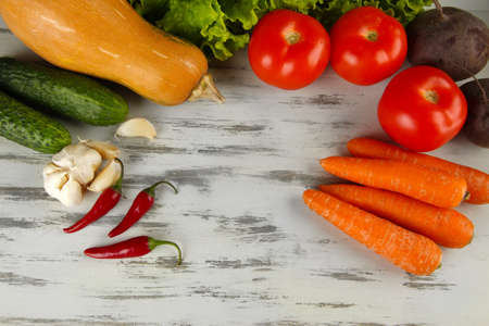 Composition of different vegetables on wooden background
