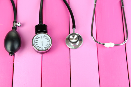 Tonometer and stethoscope on wooden table close-upの写真素材