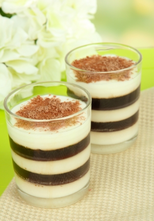 Tasty jelly coffee with milk on table on light backgroundの写真素材