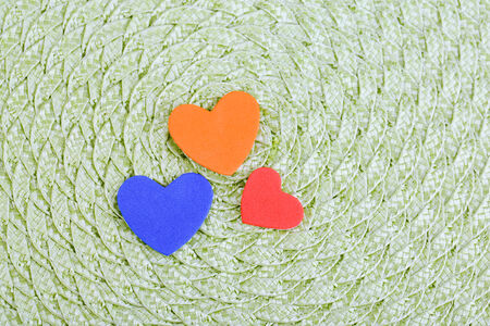Hearts made of felt on green backgroundの写真素材